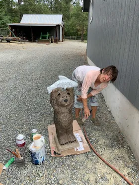 Janey painting a bear