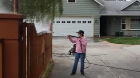 Janey power washing a fence at 70