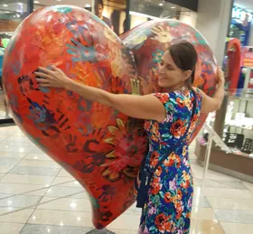 Laurie hugging a giant heart